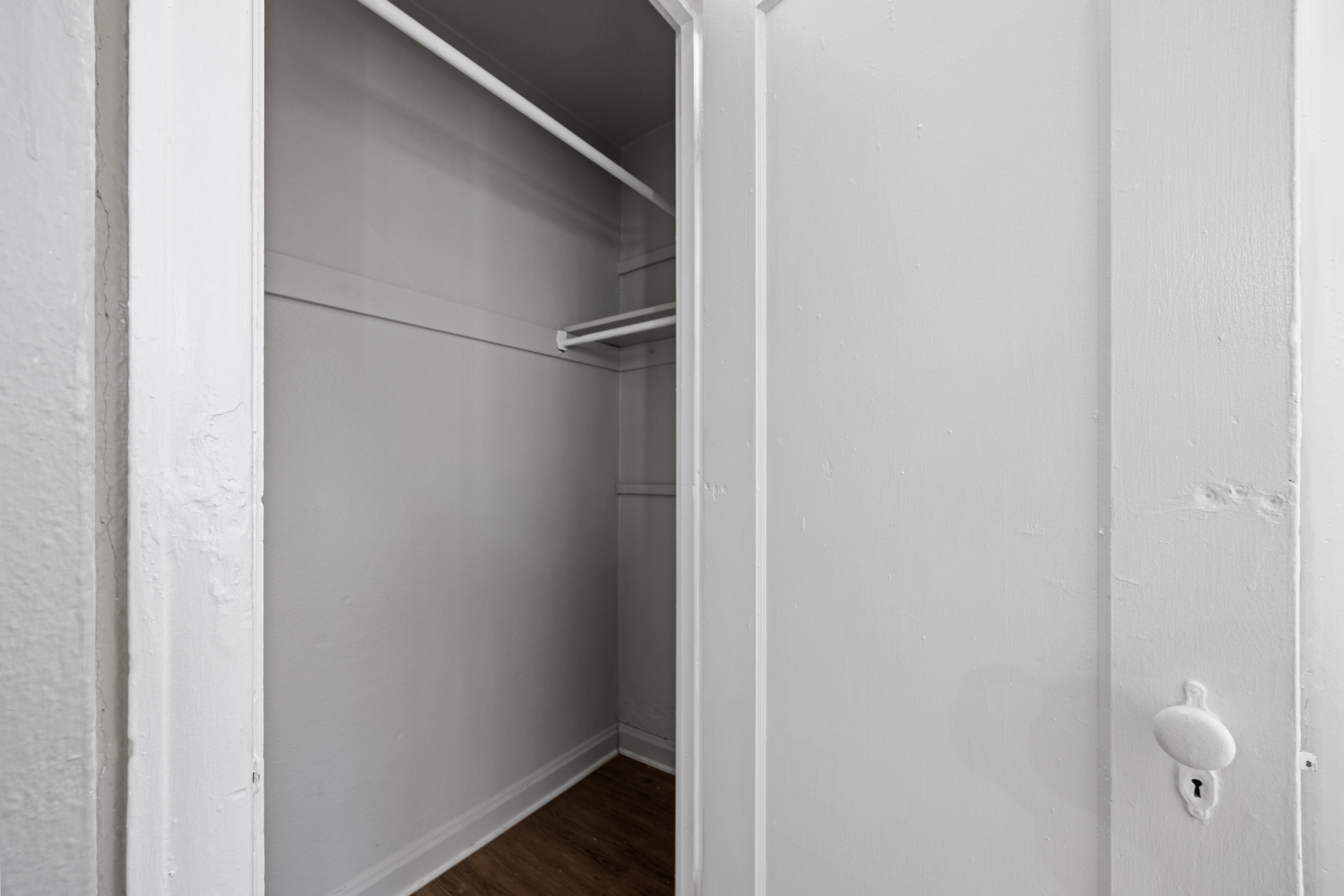 A white door with a handle is open.